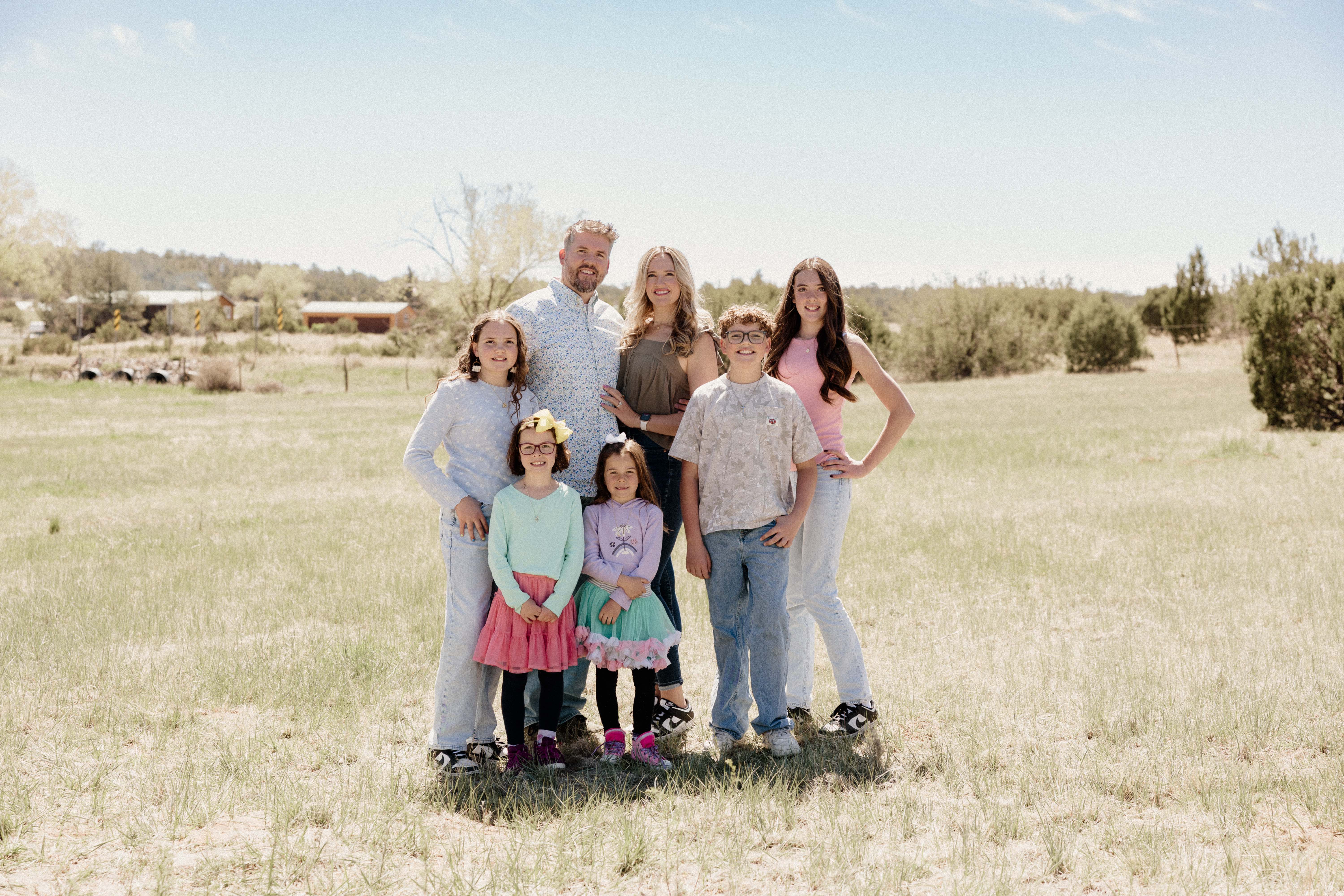 Sailor with her parents and siblings standing together in a field